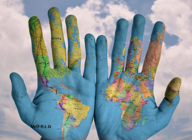 Hands painted with a world map